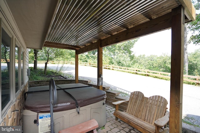 exterior space featuring fence and a hot tub