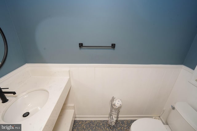 bathroom with tile patterned flooring, toilet, and vanity