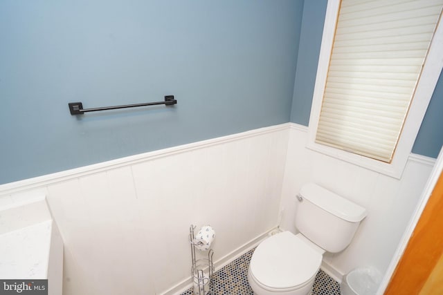 bathroom featuring wainscoting and toilet