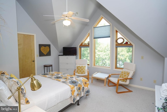 carpeted bedroom with a ceiling fan, vaulted ceiling, and baseboards