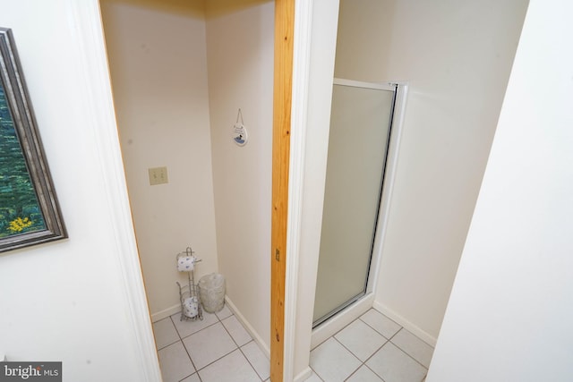 bathroom featuring tile patterned flooring and a shower with shower door