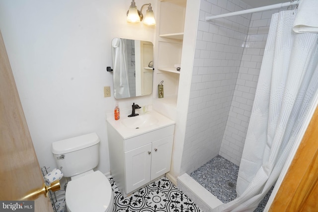 bathroom featuring toilet, vanity, curtained shower, and tile patterned floors