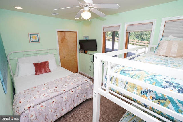 carpeted bedroom with visible vents and a ceiling fan