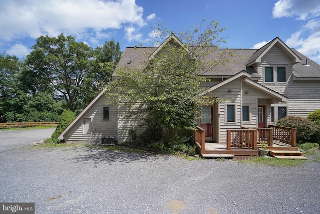 view of front of home with a wooden deck and central AC