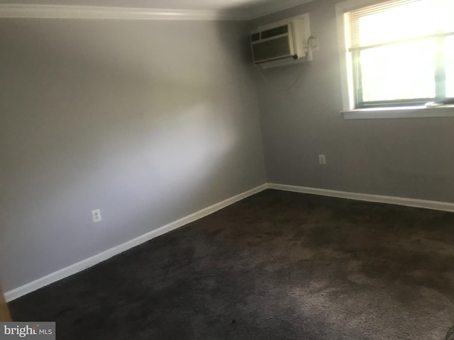 carpeted spare room with a wall mounted air conditioner