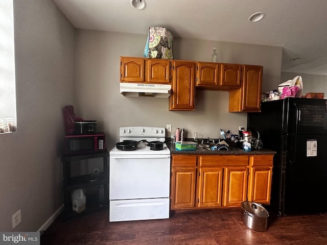 kitchen featuring white electric stove and black fridge
