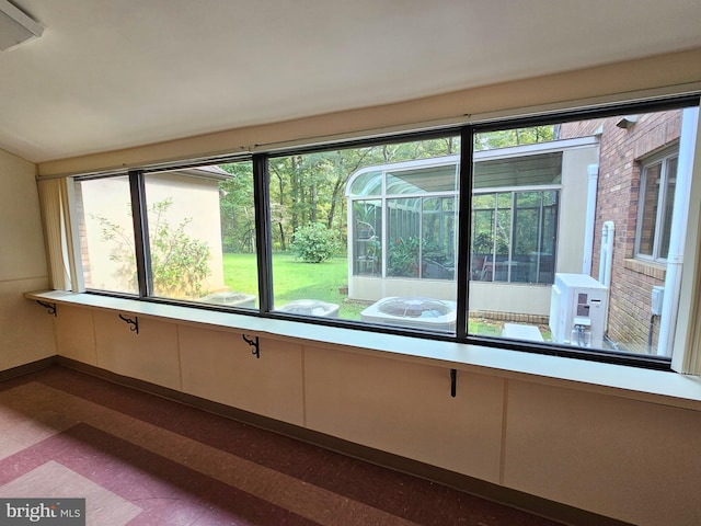 interior space with plenty of natural light and hardwood / wood-style flooring