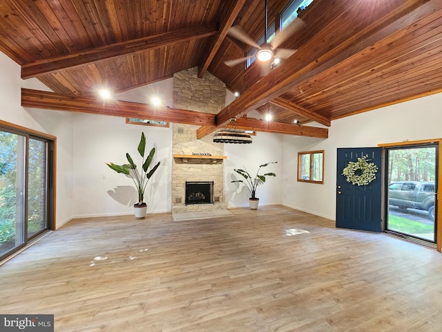 unfurnished living room featuring wooden ceiling, light hardwood / wood-style floors, and a stone fireplace