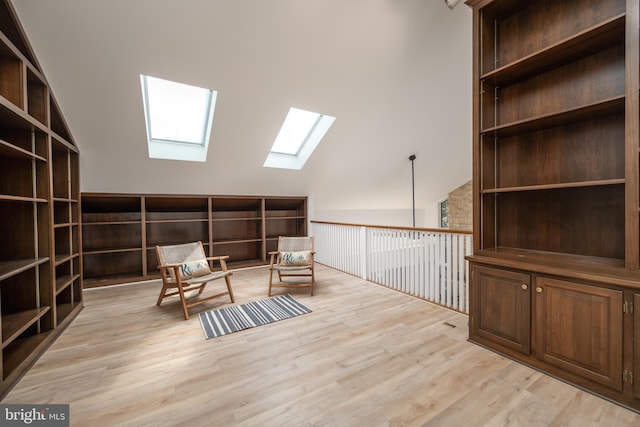 sitting room featuring light hardwood / wood-style floors and a skylight