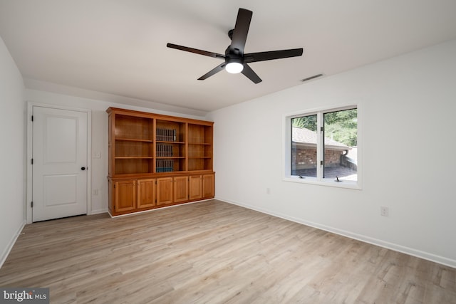 empty room with ceiling fan and light wood-type flooring