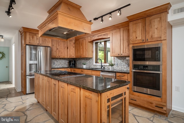 kitchen featuring a center island, dark stone counters, tasteful backsplash, and black appliances