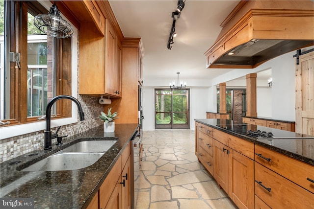 kitchen featuring a chandelier, pendant lighting, light tile floors, dark stone counters, and tasteful backsplash