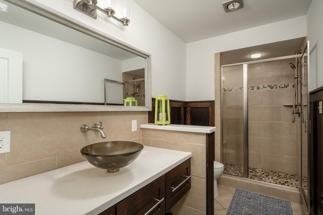 bathroom with walk in shower, backsplash, tile floors, toilet, and large vanity