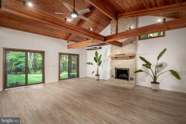 unfurnished living room with a fireplace, wooden ceiling, dark hardwood / wood-style floors, and beam ceiling