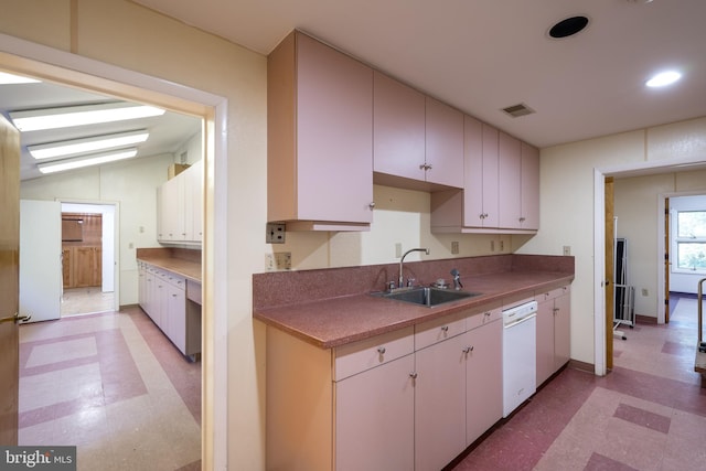 kitchen with light tile flooring, lofted ceiling, white appliances, and sink