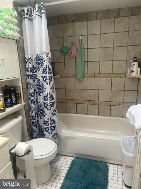 full bathroom with shower / bath combination with curtain, toilet, and tile flooring