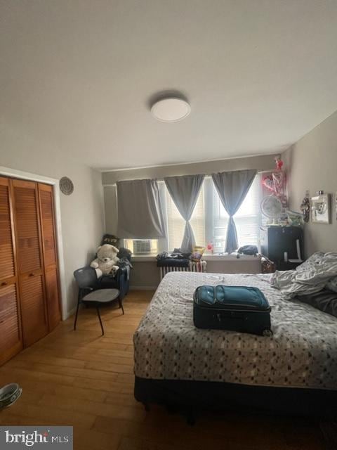 bedroom featuring a closet and hardwood / wood-style flooring