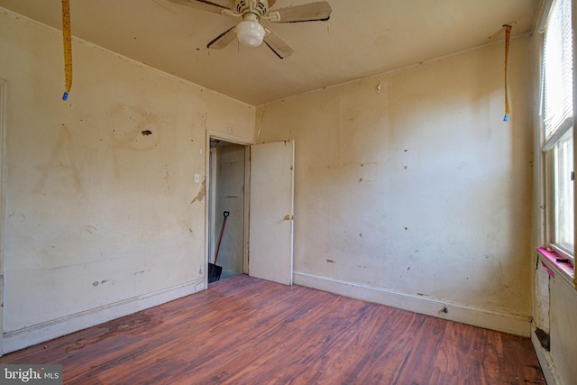 unfurnished room featuring ceiling fan and dark wood-type flooring