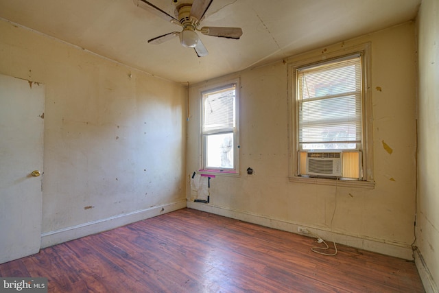 empty room featuring dark hardwood / wood-style flooring, ceiling fan, and a healthy amount of sunlight