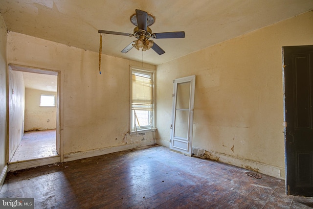 unfurnished room with ceiling fan and dark wood-type flooring