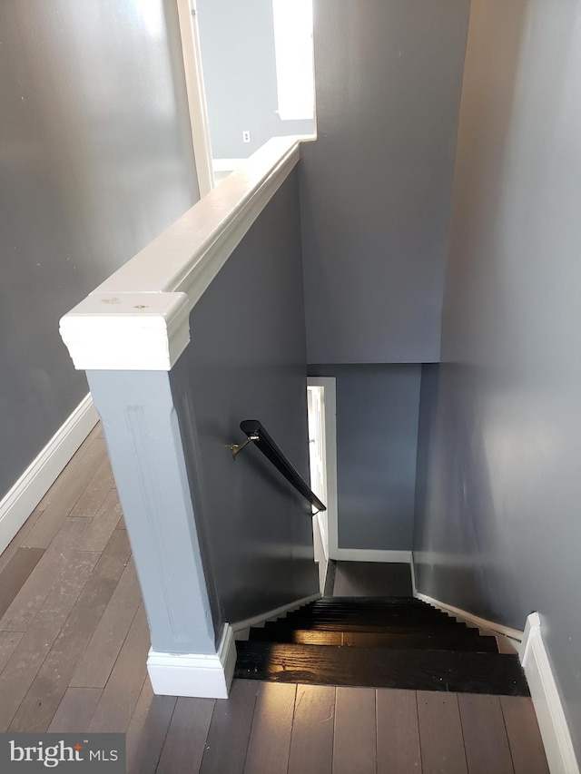 stairs with dark wood-type flooring