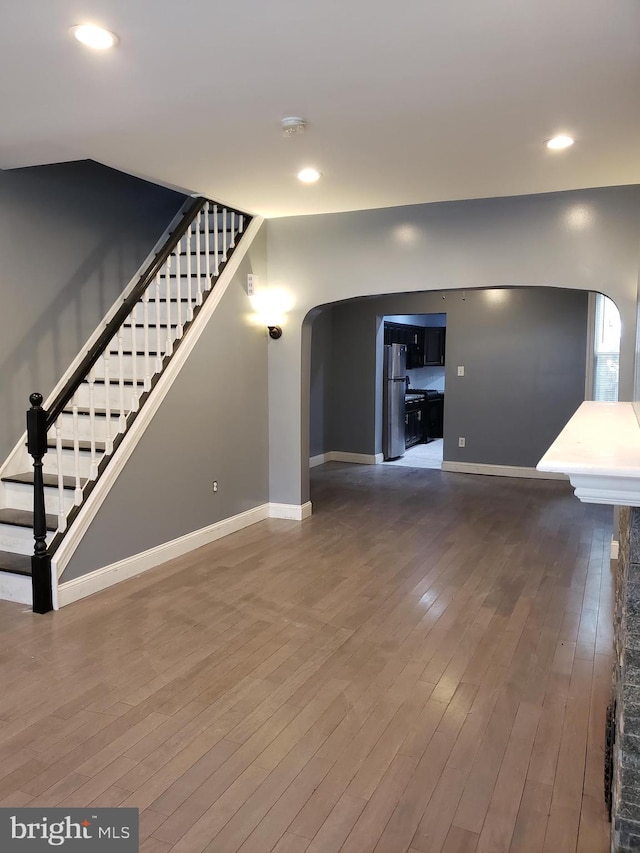 unfurnished living room with dark hardwood / wood-style floors