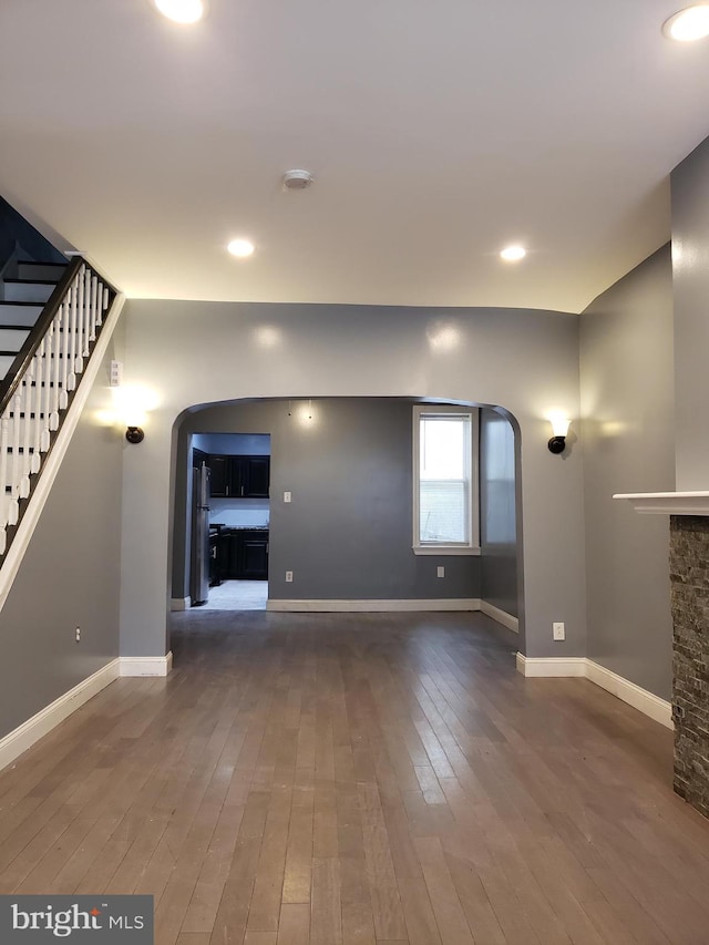 unfurnished living room featuring dark hardwood / wood-style floors