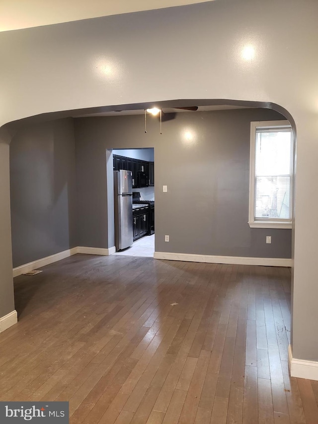 unfurnished living room featuring dark wood-type flooring