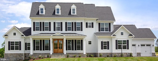 new england style home with a front lawn and a garage