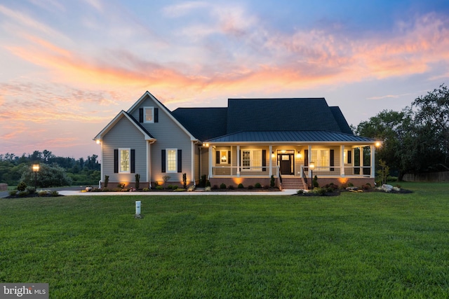 view of front of home with a lawn and covered porch