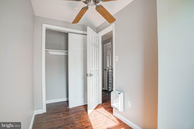 unfurnished bedroom featuring ceiling fan, dark hardwood / wood-style floors, and a closet