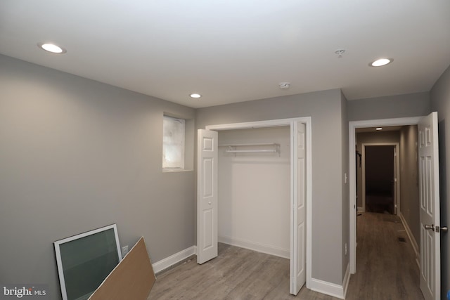 unfurnished bedroom featuring a closet and light hardwood / wood-style flooring