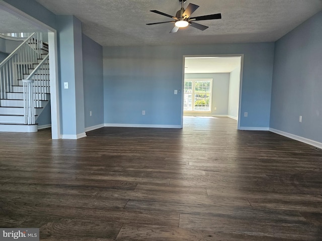 unfurnished room with ceiling fan, a textured ceiling, and dark wood-type flooring