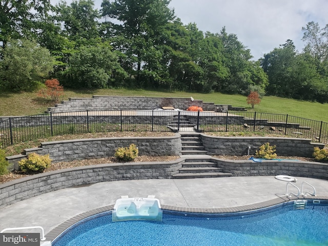 view of pool featuring a lawn and a patio