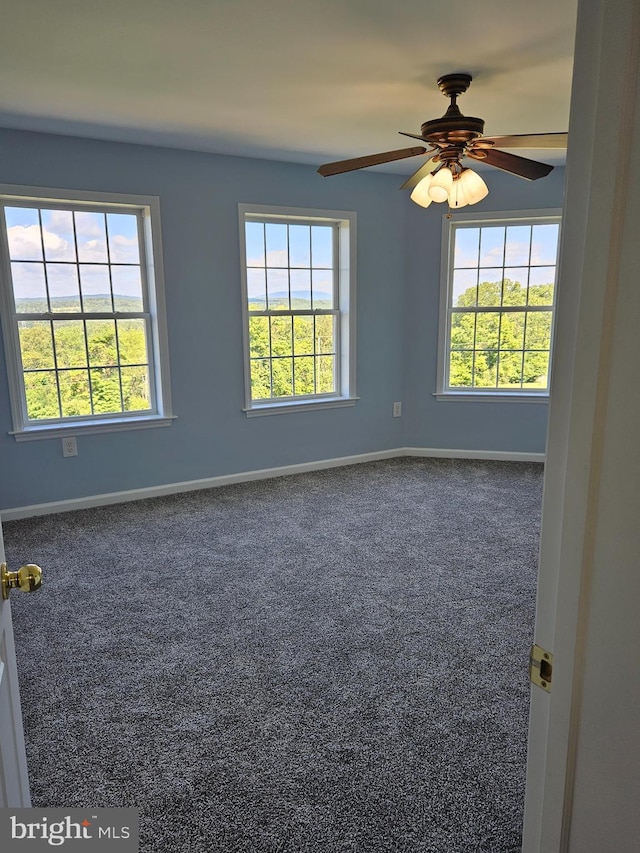 carpeted empty room featuring ceiling fan