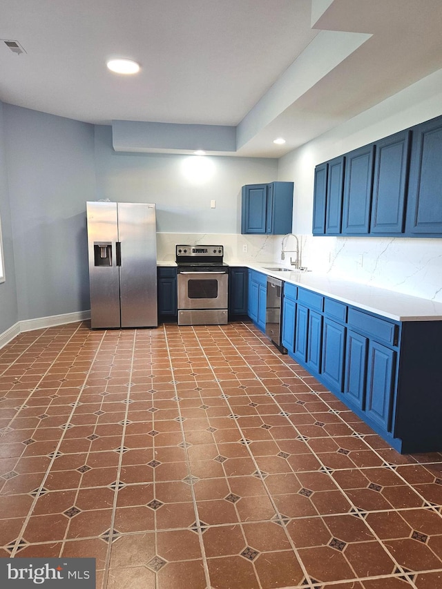 kitchen featuring tile floors, blue cabinets, sink, stainless steel appliances, and tasteful backsplash