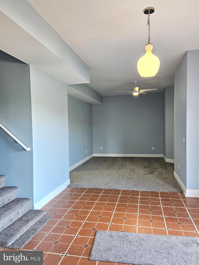 tiled spare room featuring ceiling fan