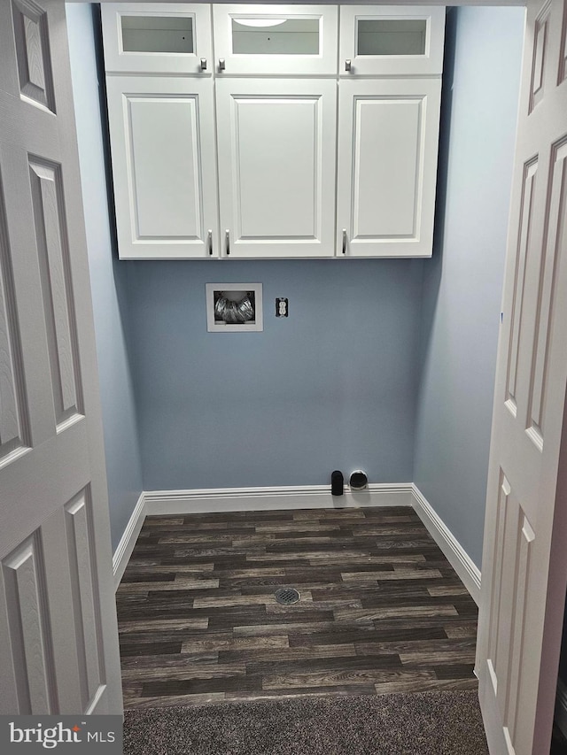 laundry area featuring dark hardwood / wood-style floors, washer hookup, and cabinets