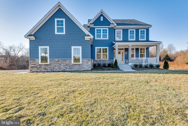 view of front of house featuring a front lawn and covered porch