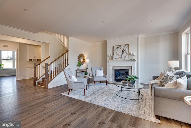 living room featuring dark hardwood / wood-style flooring and ornamental molding