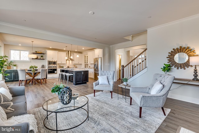 living room featuring crown molding and light hardwood / wood-style floors