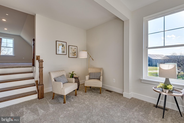 living area with light carpet and vaulted ceiling