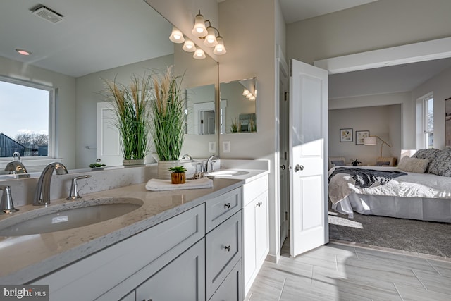 bathroom with tile floors and dual bowl vanity