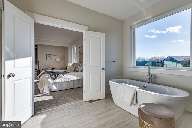 bathroom featuring a bathtub and tile flooring