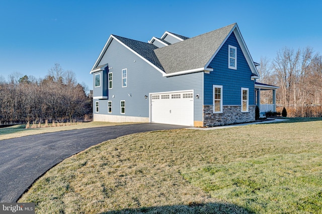 view of front of home with a front yard and a garage