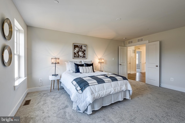 bedroom featuring light carpet