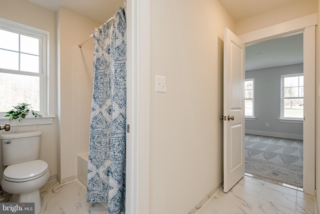 bathroom featuring shower / bath combo, toilet, and tile flooring