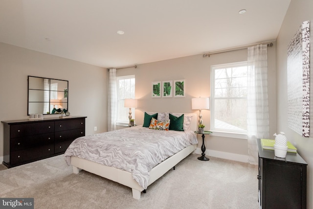 bedroom featuring light carpet