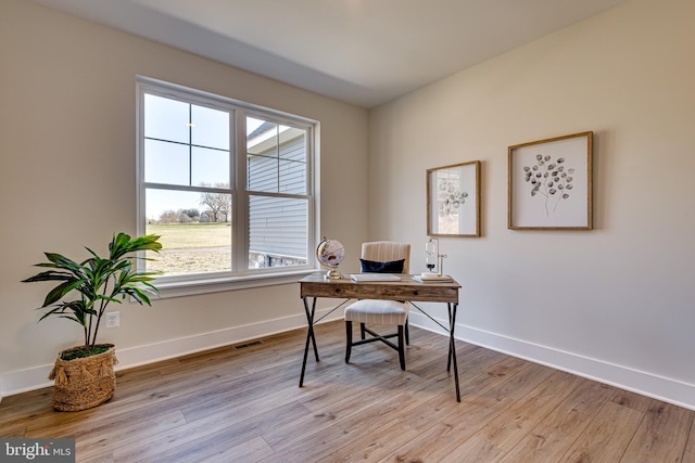 office with light hardwood / wood-style flooring