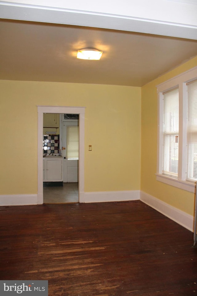 unfurnished room featuring dark hardwood / wood-style flooring